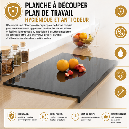 Planche à découper encastrable noire en acrylique sur plan de travail de cuisine moderne avec fruits découpés